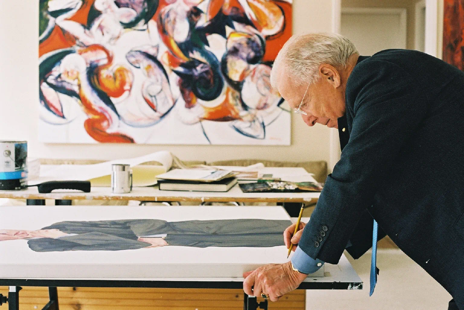 Arthur Erickson signing his portrait in Peter John Voormeij's studio